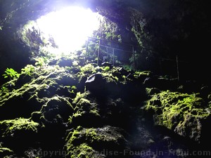 Picture of people cave exploring inside the Hana Lava Tube (Kaeleku Caverns) on the island of Maui, Hawaii.