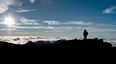 Person watching sunrise on Haleakala.