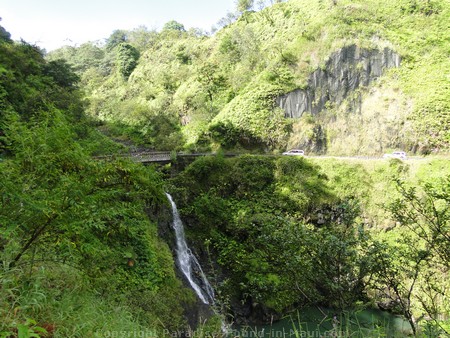 Picture of a waterfall under a one-lane bridge along the Road to Hana.