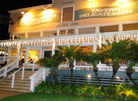 Haliimaile General Store exterior lit up at night.