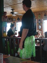 Picture of a male server wearing a colourful hula skirt at the Cheeseburger in Paradise Maui restaurant in Lahaina.