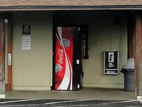 Picture of the Coca Cola vending machine and payphone at the Hana Airport in Maui, Hawaii.