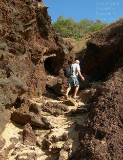 Picture of a man climbing the trail to Little Beach Maui at the base of the Pu'u Ola'i cinder cone at the north end of Big Beach
