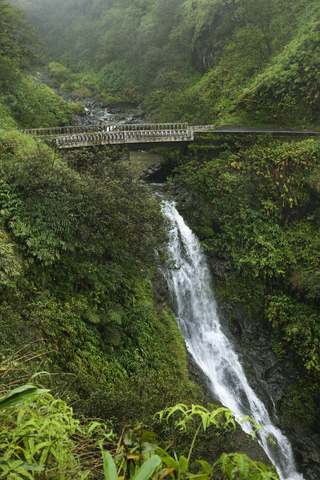 Road to Hana Maui one lane bridge with waterfall