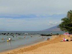 Picture of sunbathers and swimmers at Ulua Beac, Wailea, Maui, Hawaii.